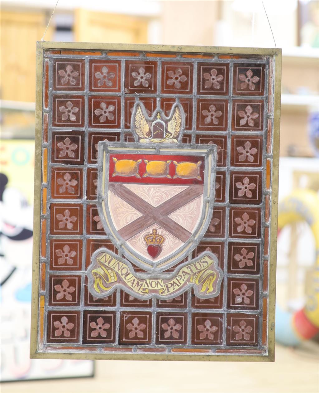 A brown stained glass panel, brass framed, 44.5 x 34cm (a.f.)